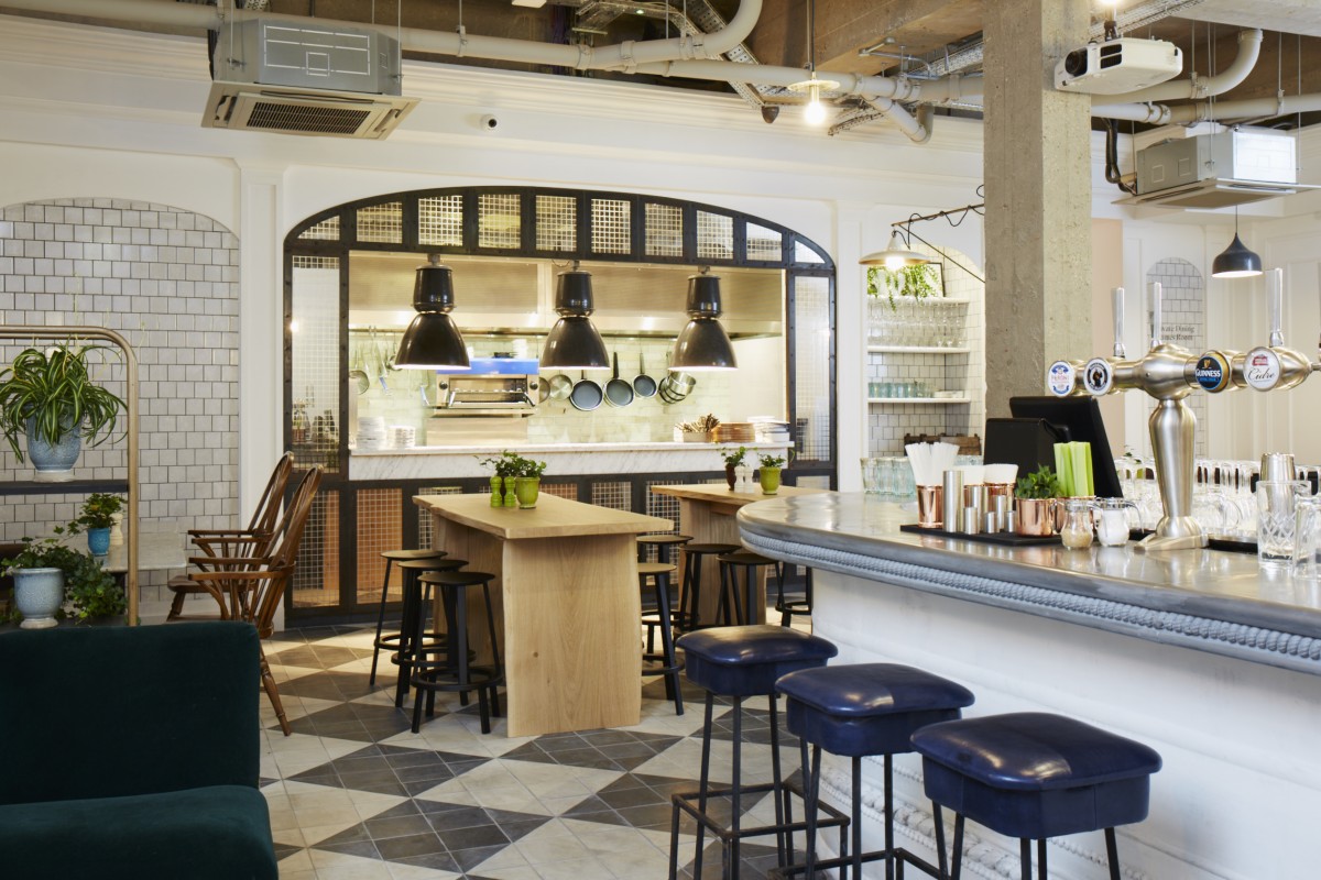 Private dining room with open kitchen, perfect for casual meetings and events.