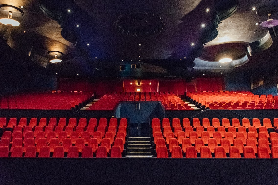 Genesis Cinema theater with vibrant red seating, ideal for presentations and performances.