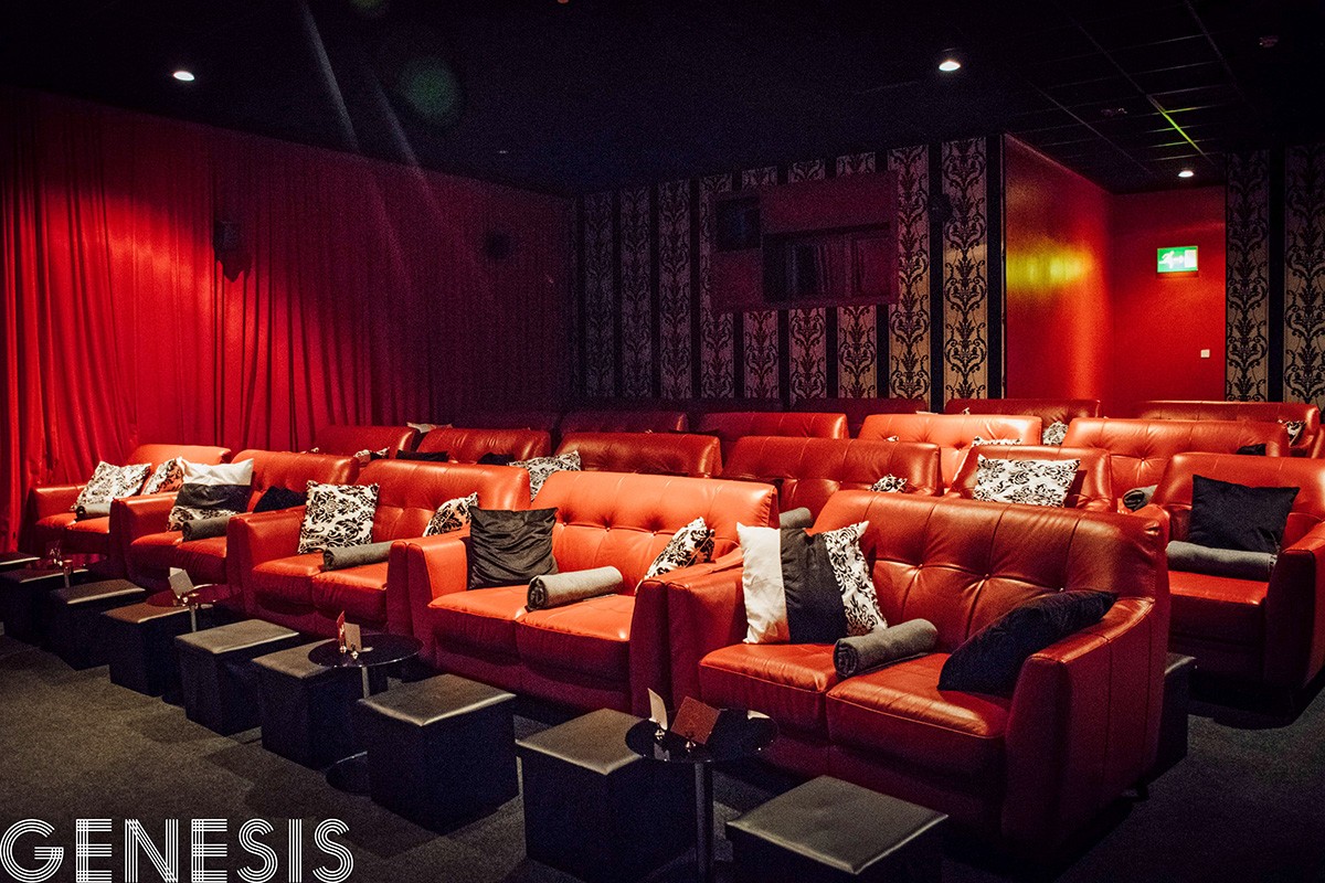 Stylish Genesis Cinema with plush red leather seating for exclusive events and screenings.