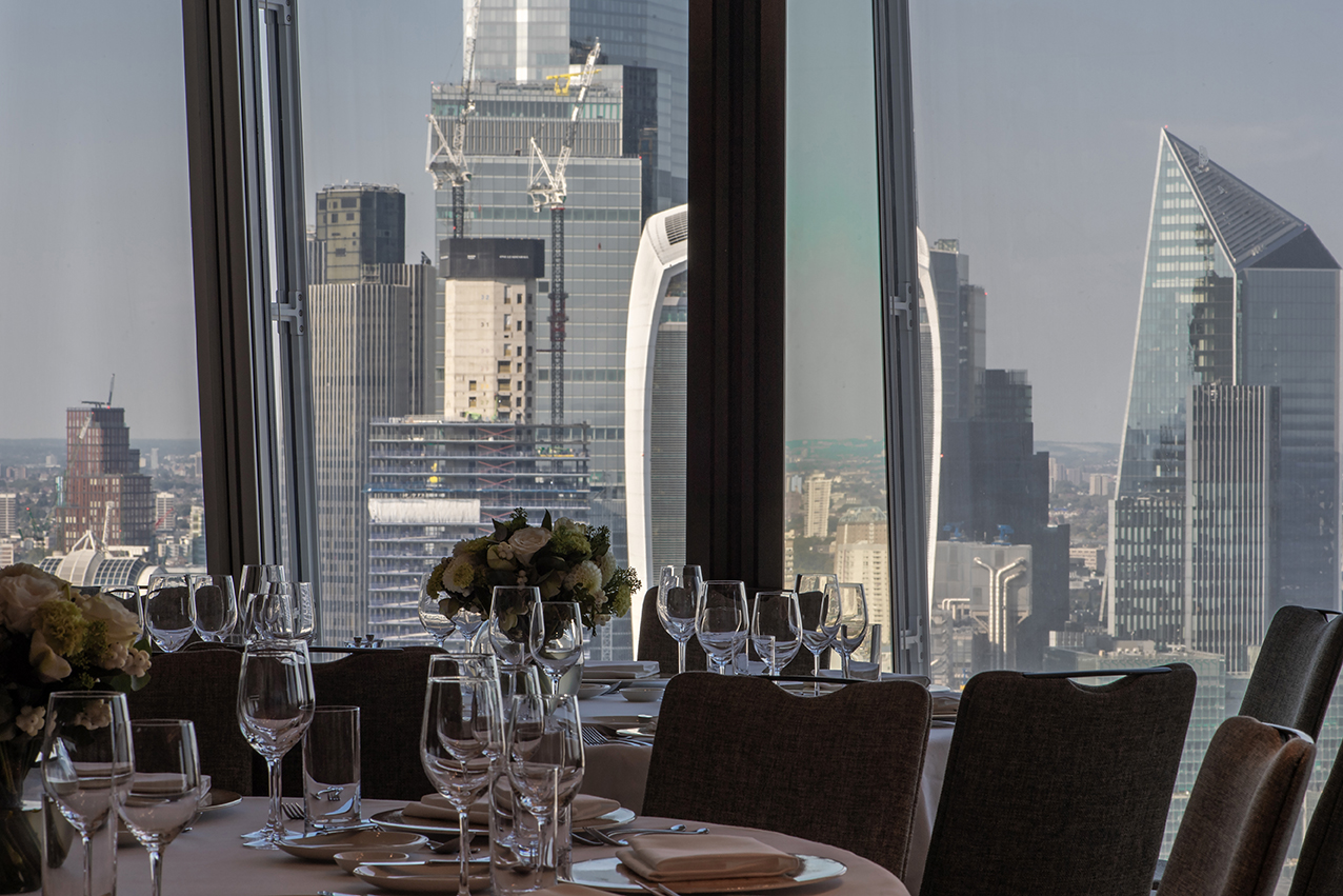 Sophisticated dining setup with skyline view at Shangri-La The Shard, London event space.