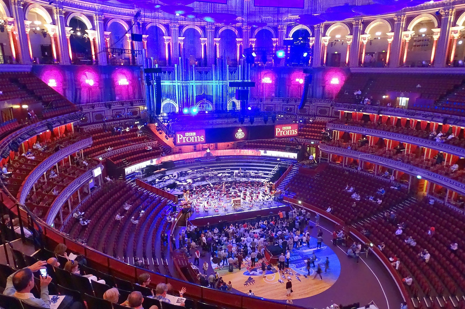 Royal Albert Hall concert venue with vibrant lighting and tiered seating for performances.