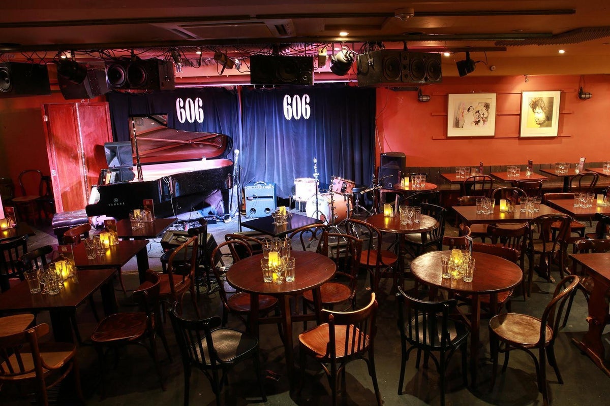 Cozy live music venue 606 Club with grand piano, ideal for events and gatherings.