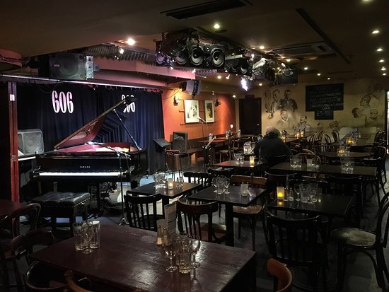 Intimate jazz venue with grand piano, perfect for private events and gatherings.