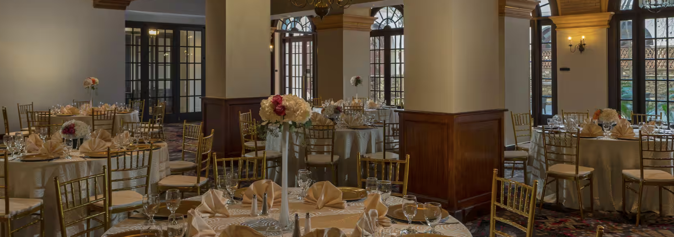 Elegant banquet room with floral centerpieces for weddings and corporate events.