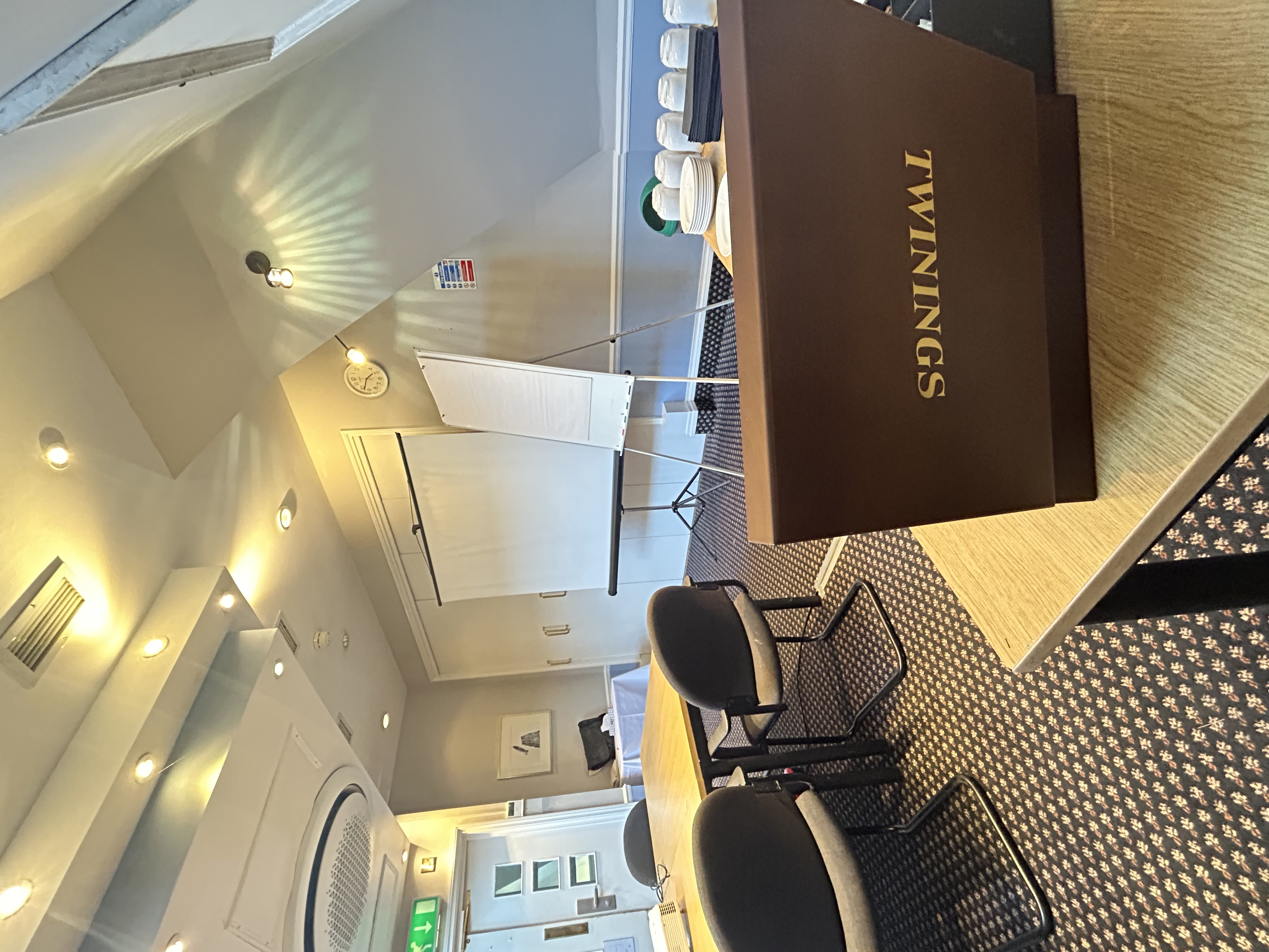 Meeting room at Mercure Brighton with projector screen for workshops and strategy sessions.