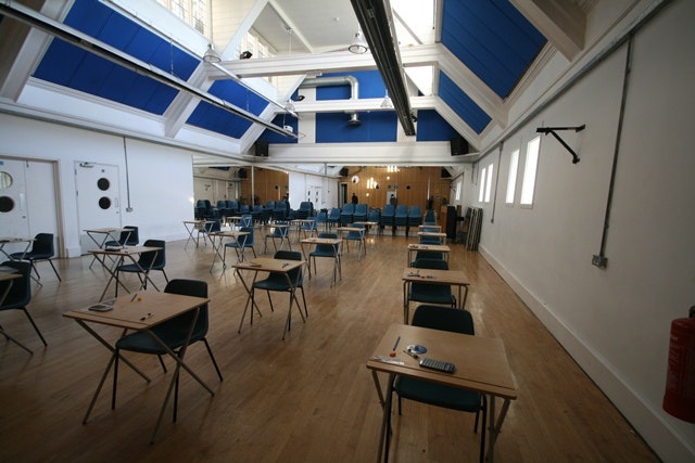 Internet cafe meeting space with high ceiling, ideal for workshops and seminars.