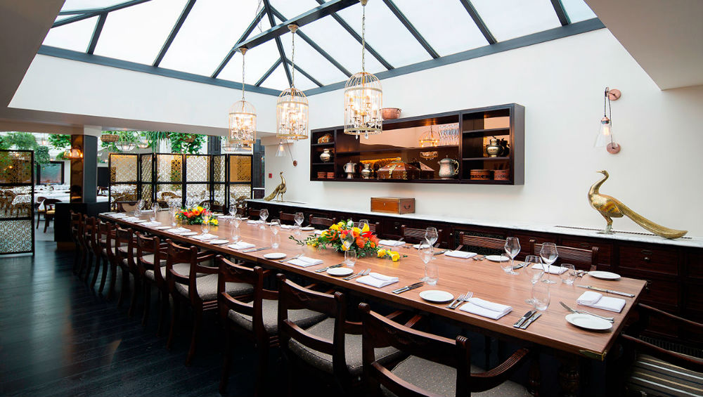 Elegant dining room with a long table, perfect for intimate gatherings and corporate events.