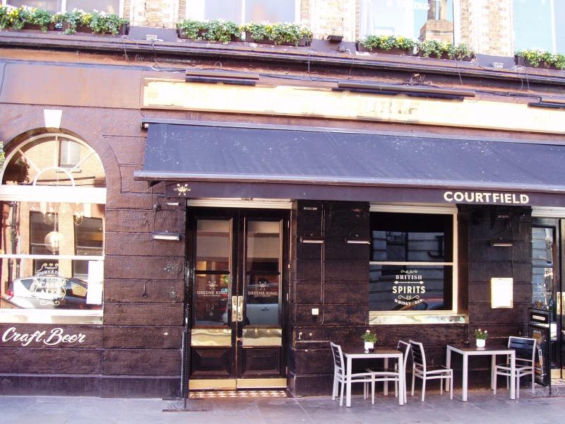 Stylish pub exterior with outdoor seating, ideal for casual meetings and networking events.