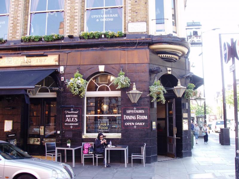 Charming pub exterior with outdoor seating, perfect for networking events and casual gatherings.