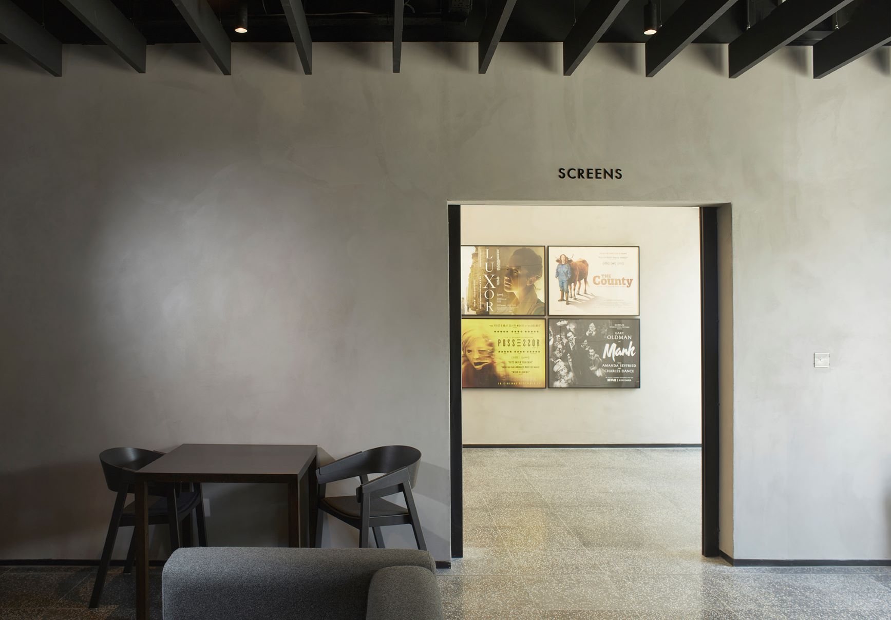 Curzon Hoxton bar: modern meeting space with screens for networking events.