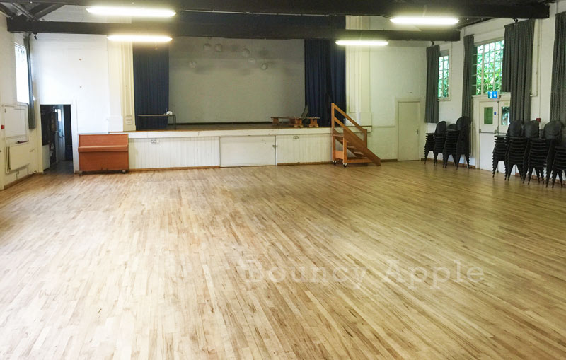 Mortlake Village Hall: spacious event venue with polished wooden floor for gatherings.
