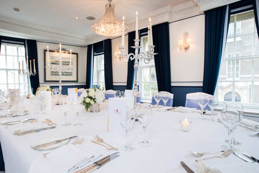 Queen Suite dining table with candelabras, ideal for corporate dinners and events.