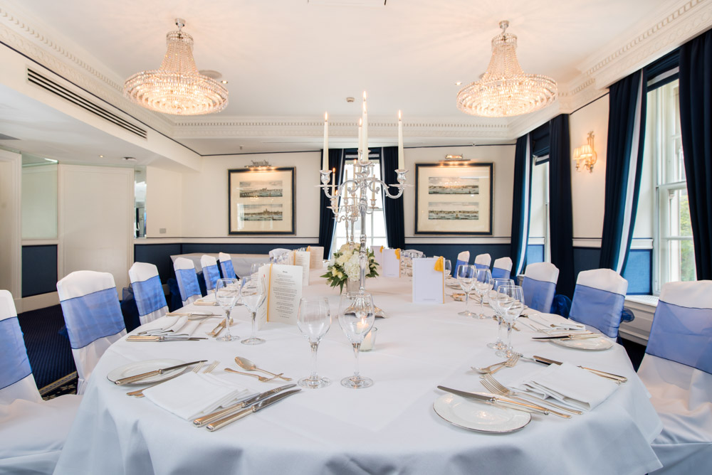 Elegant Queen Suite dining table with candelabra for corporate dinners and events.
