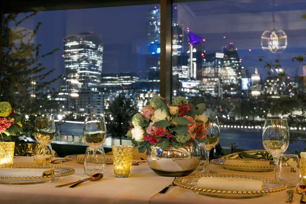 Elegant dining table with skyline view at The Ivy Tower Bridge for corporate events.