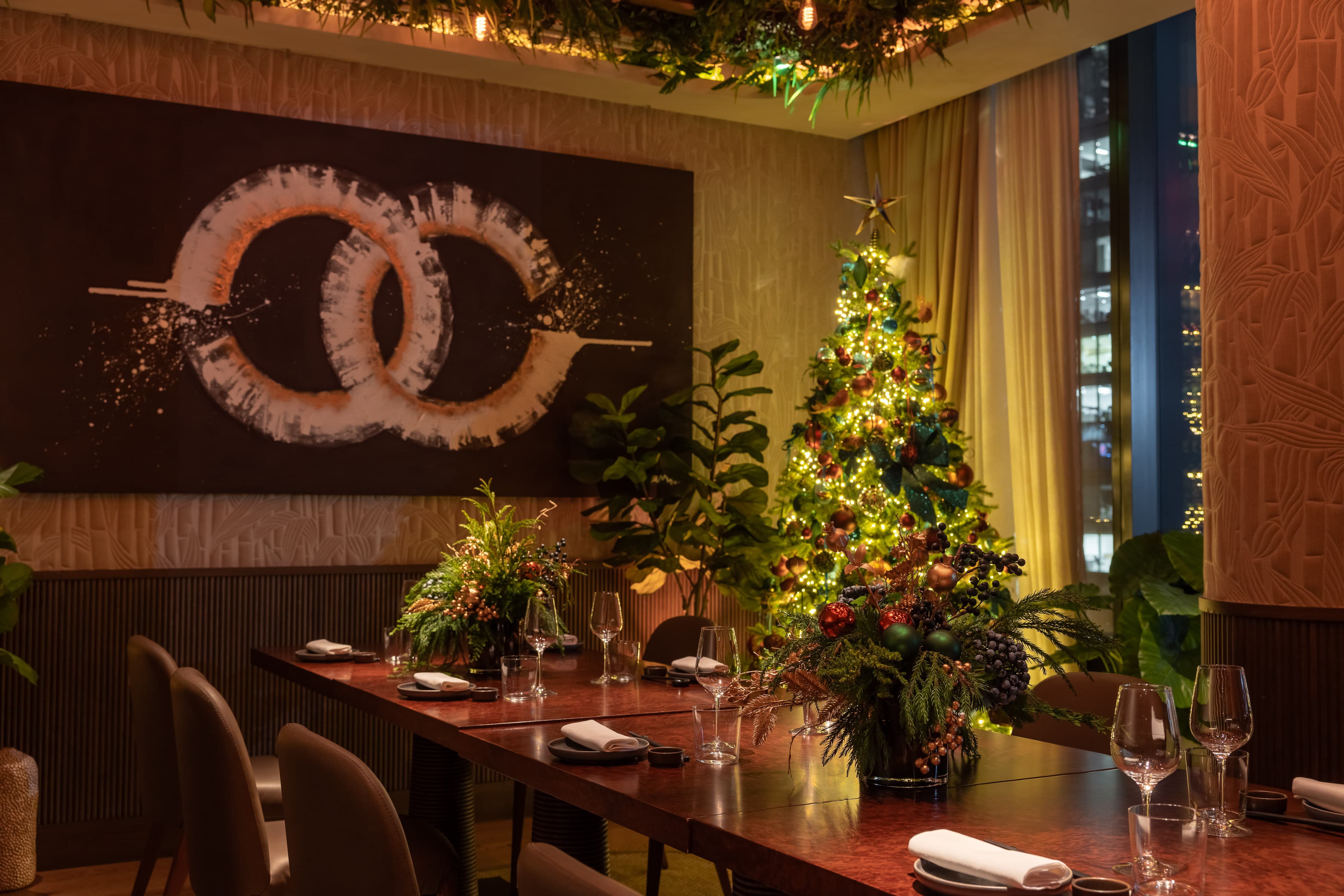 Upscale private dining room with festive decor for executive holiday event dinners.