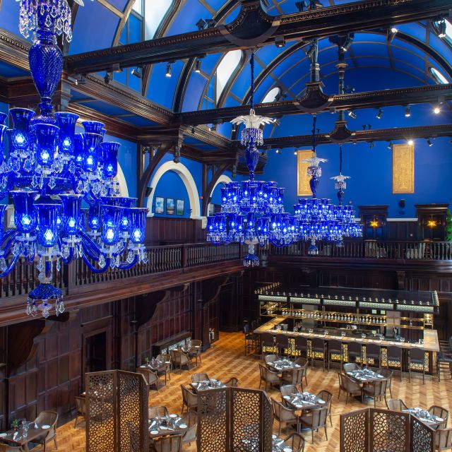 Tea Lounge at The LaLiT London with elegant blue chandeliers, perfect for upscale events.