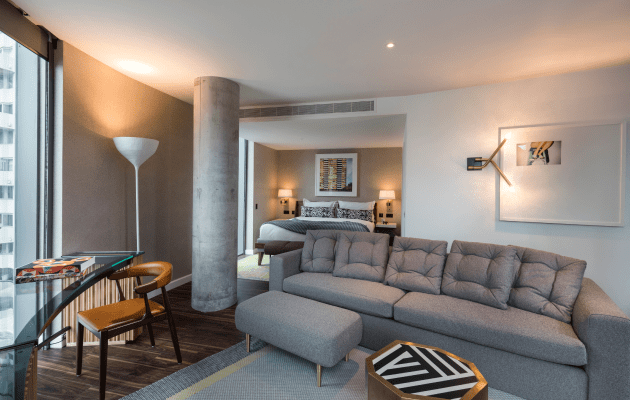 Modern hotel suite with cozy seating, perfect for meetings and gatherings at Bankside Hotel.