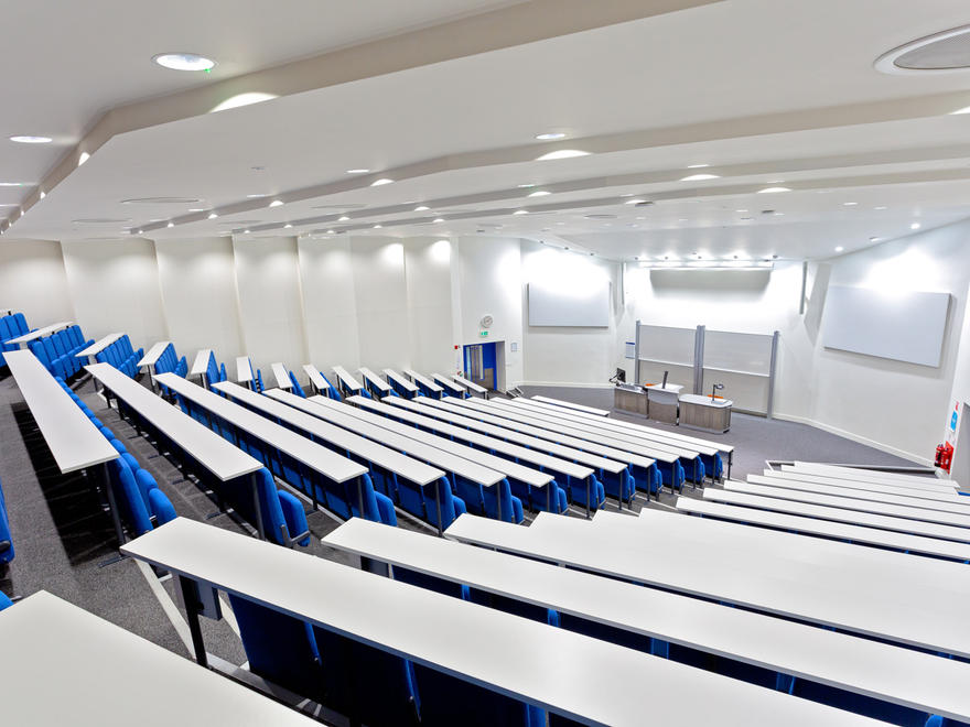 Imperial College Business School auditorium with tiered seating for impactful lectures and meetings.