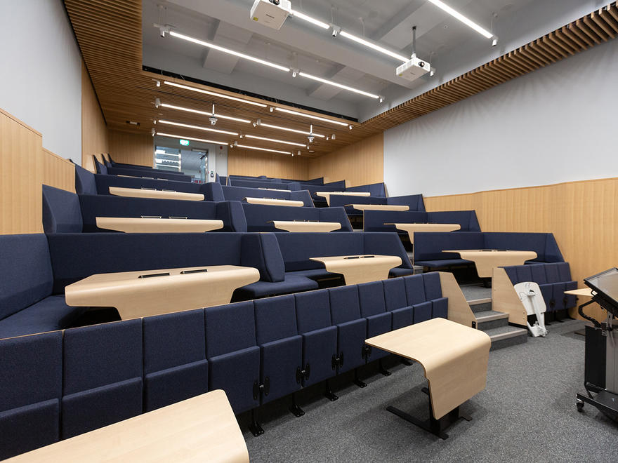 Modern Imperial College Business School auditorium with tiered seating for corporate events.