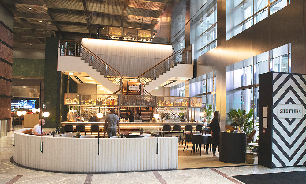 Modern event venue with elegant staircase, ideal for meetings and networking at Canary Wharf.