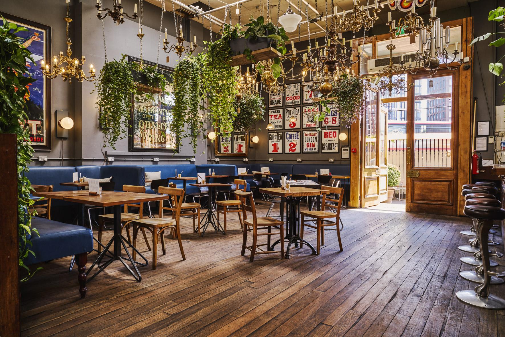 Stylish garden venue with greenery and chandeliers for intimate gatherings and meetings.