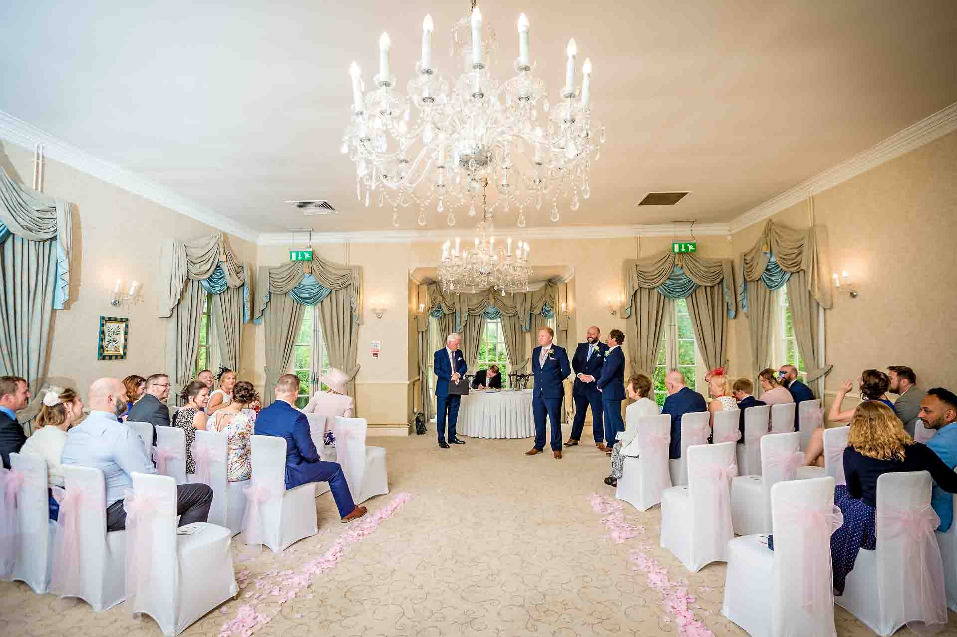 Elegant wedding ceremony setup in Pamper & Prep Suite, De Courceys Manor, with floral decor.