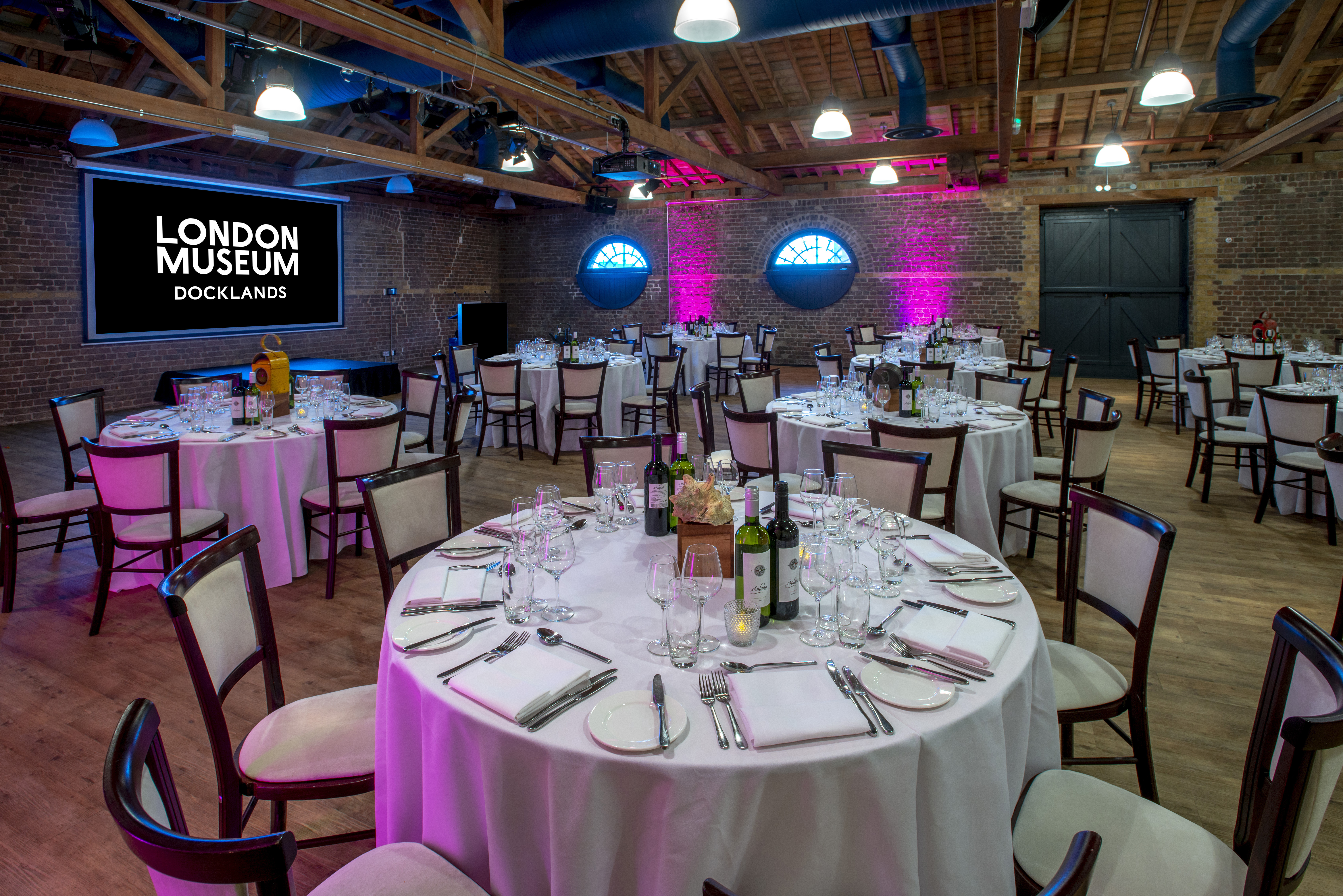 London Museum Docklands event space, pink lighting, dinner gala