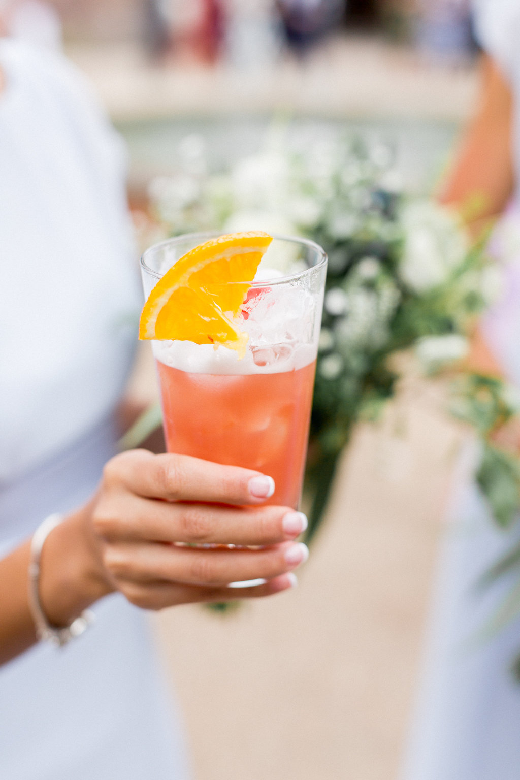Vibrant cocktail with orange slice in Terrace Boardroom, perfect for summer events.