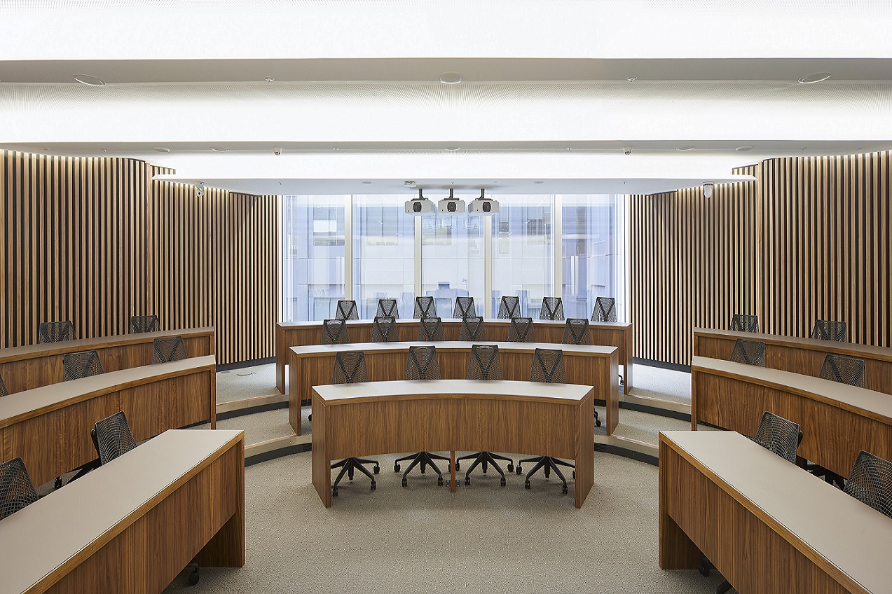 Modern Executive Education Classroom with curved seating for workshops in London.