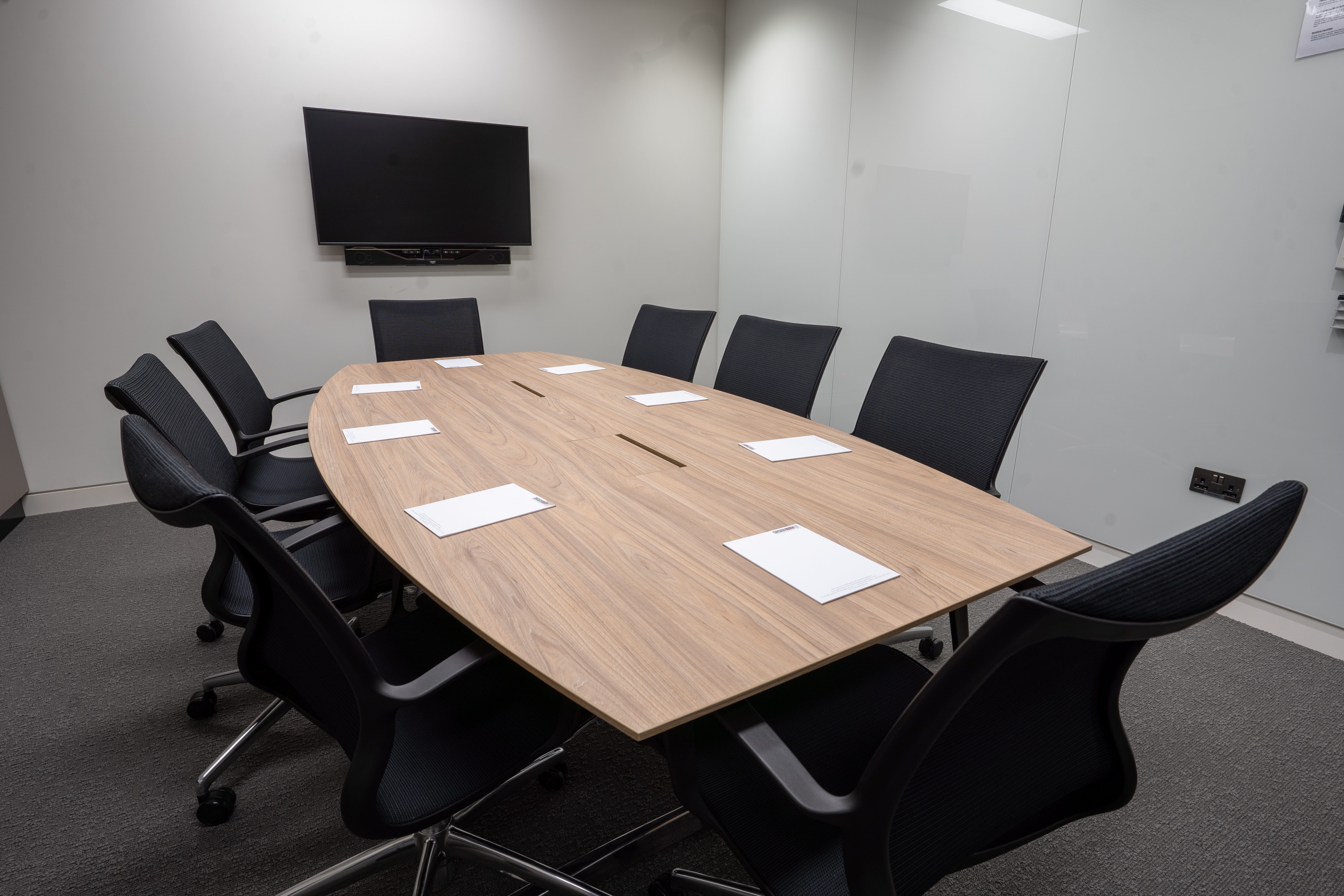 Modern conference room with oval table and ergonomic chairs in London Centre.