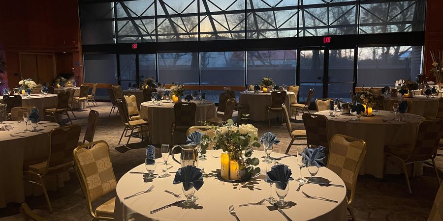 Elegant event space at Clark Street Terrace with round tables and floral centerpieces.
