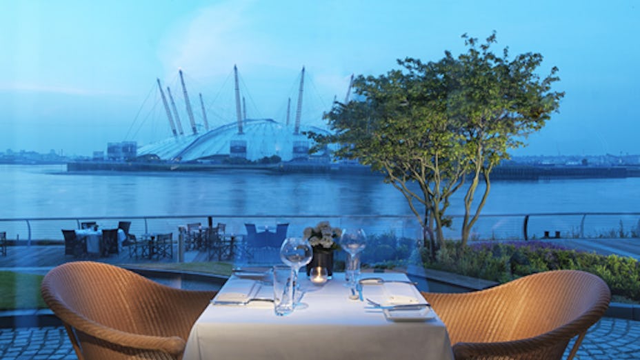 Elegant dining table with waterfront view at Scoff & Banter, ideal for upscale events.