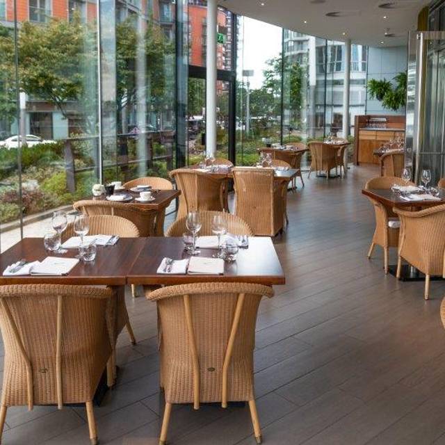 Stylish dining area with wicker chairs at Scoff & Banter, perfect for upscale events.