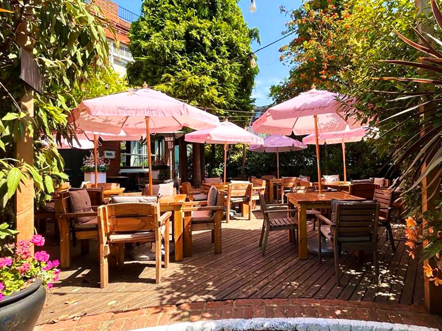 Beer Garden at Winning Post with pink umbrellas, ideal for summer events and gatherings.