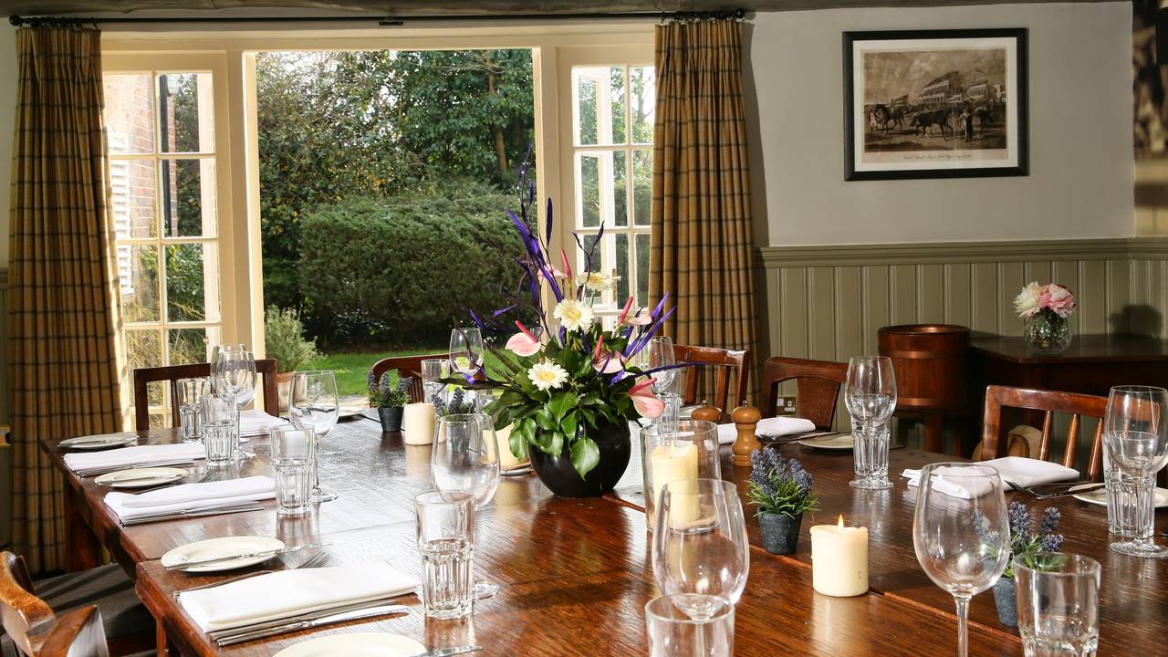 Beer Garden dining setup with floral centerpiece, ideal for events and meetings.