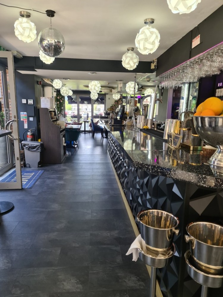 Modern Aqua Vista Bistro Bar with vibrant lighting, ideal for networking events.