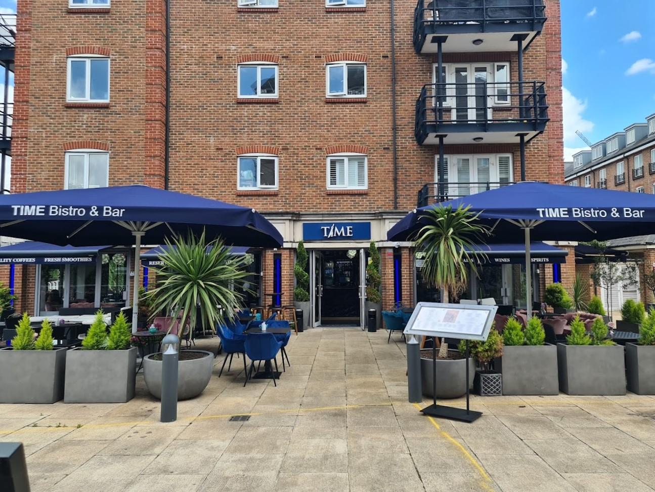 Outdoor terrace at Aqua Vista Bistro Bar with blue umbrellas, perfect for networking events.