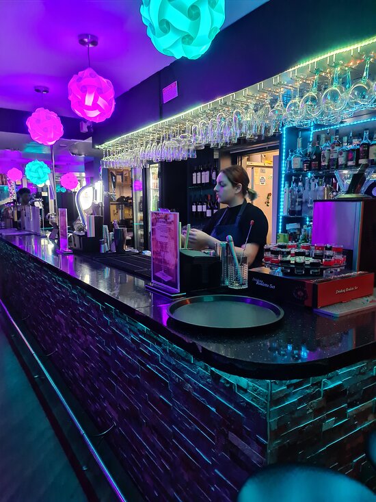 Vibrant Aqua Vista Bistro Bar with colorful lighting, ideal for networking events.
