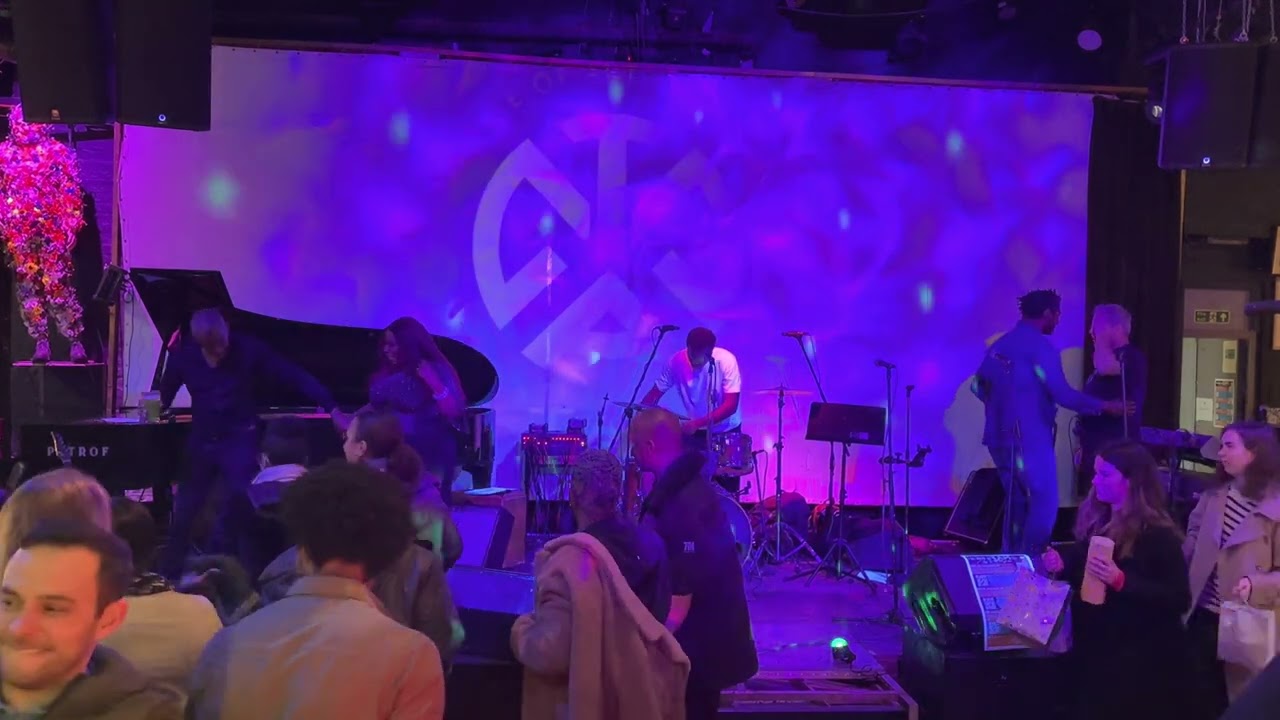 Vibrant TAM's Vineyard event space for live performance with musicians and colorful lighting.