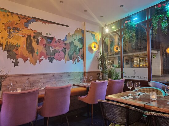 Stylish restaurant interior with vibrant art, ideal for intimate gatherings and events.