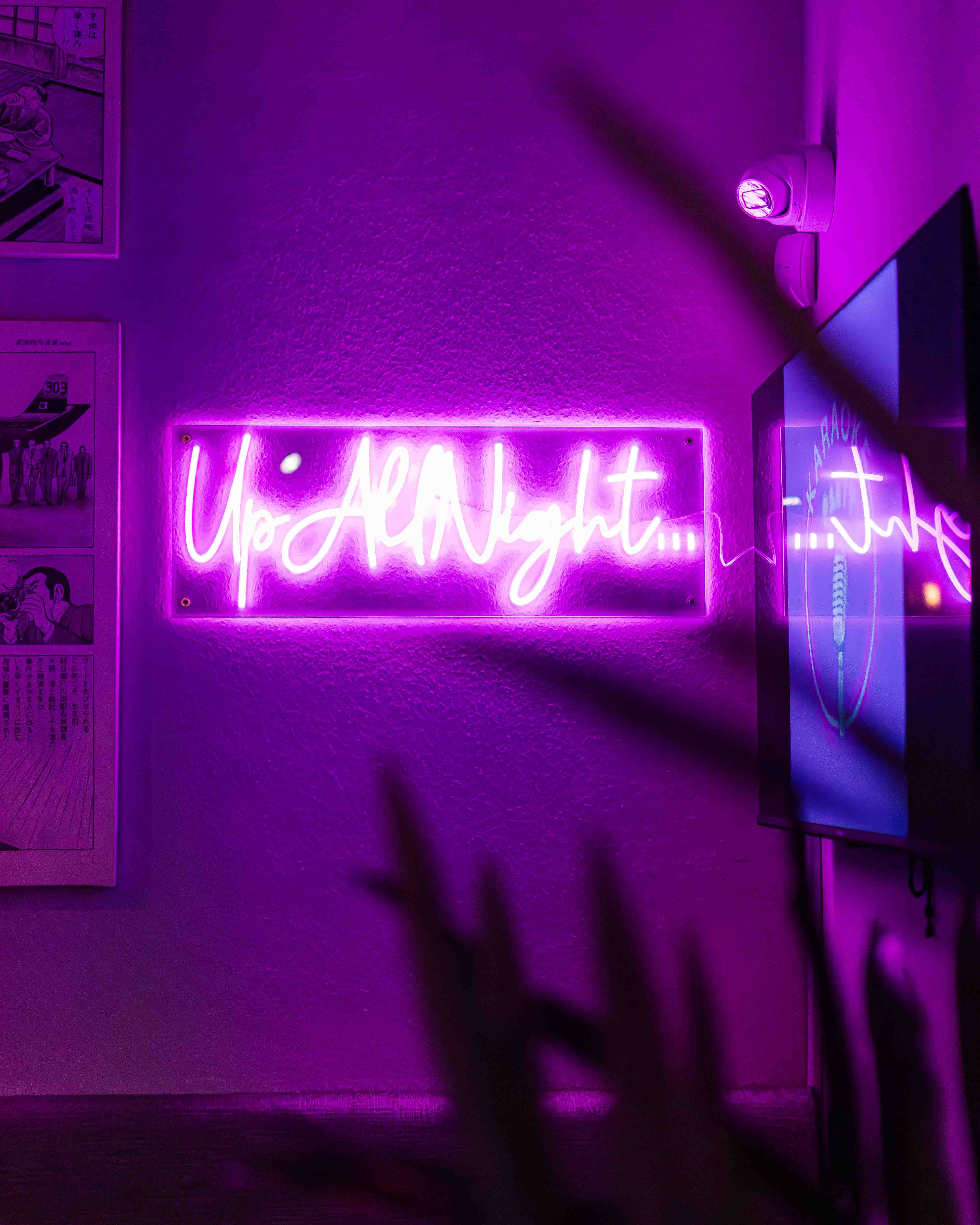 "Vibrant neon 'Up All Night' sign at Bath Karaoke for lively networking events."