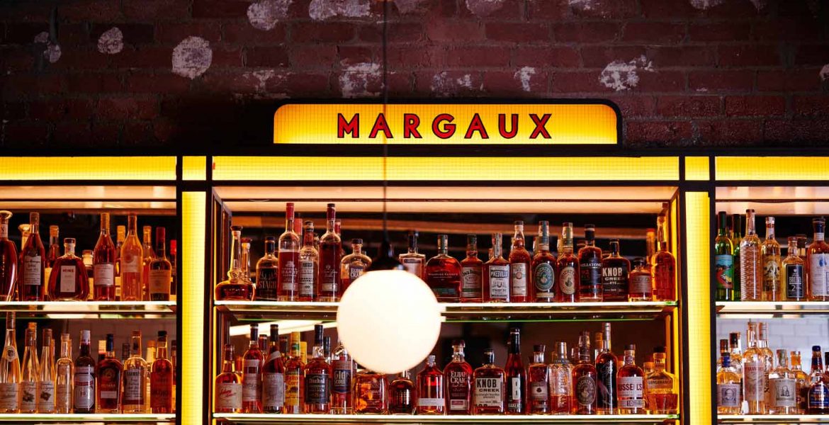 "Vibrant Margaux bar with premium spirits, perfect for networking events and socializing."