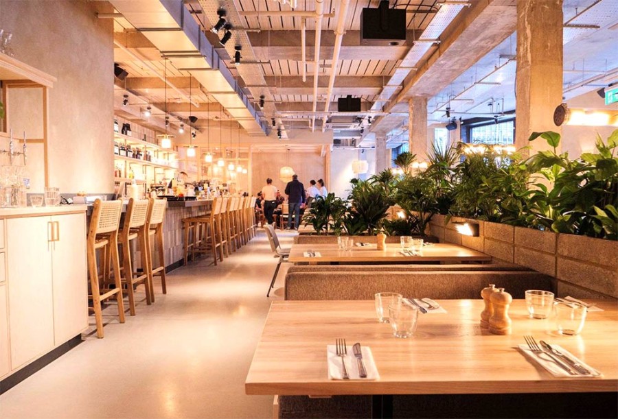 Modern Main Restaurant at Caravan Canary Wharf, ideal for events and gatherings.