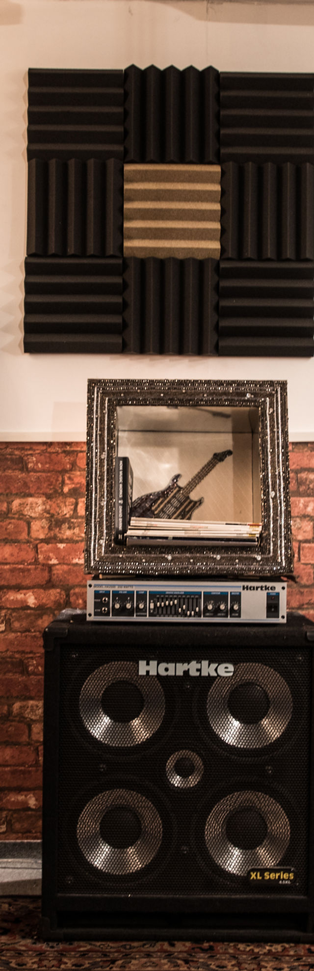 Guitar in vintage frame at Rug 'n' Roll Music Studio for unique event ambiance.