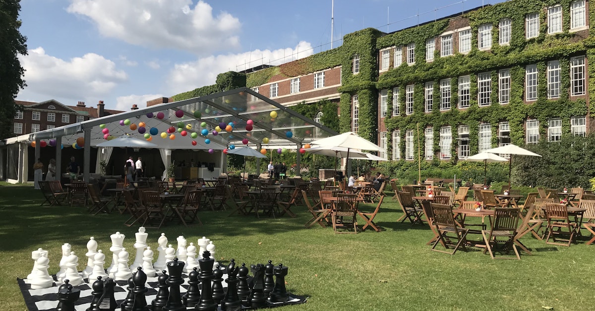 Outdoor event space at York Lawns with colorful tent and oversized chess set.