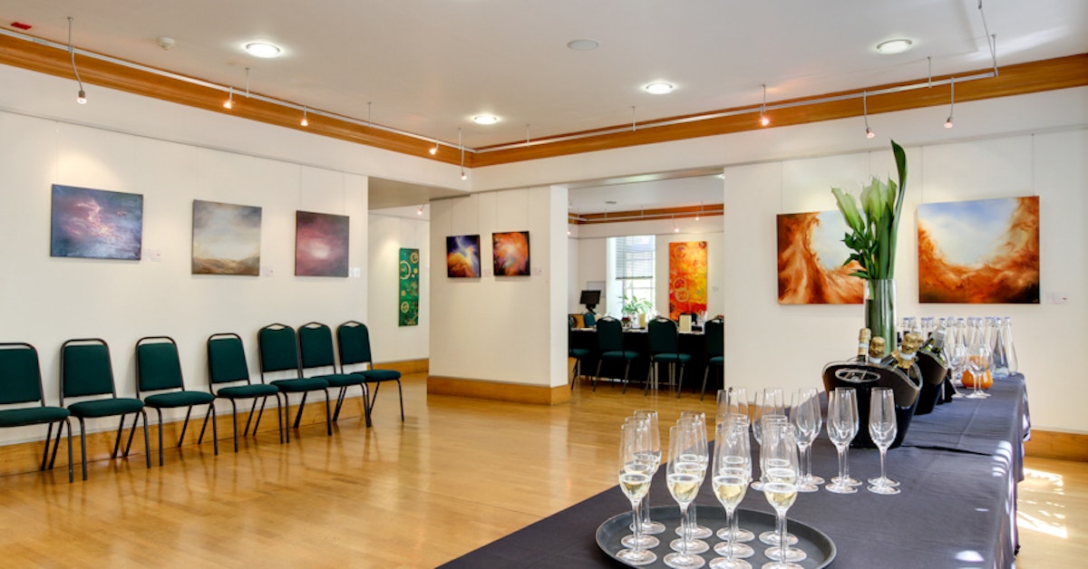 Tuke Hall event space with elegant setup, vibrant art, perfect for meetings or receptions.