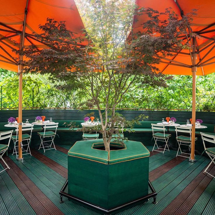 Roof Terrace at Casa Cruz London with orange umbrellas, ideal for outdoor events and gatherings.