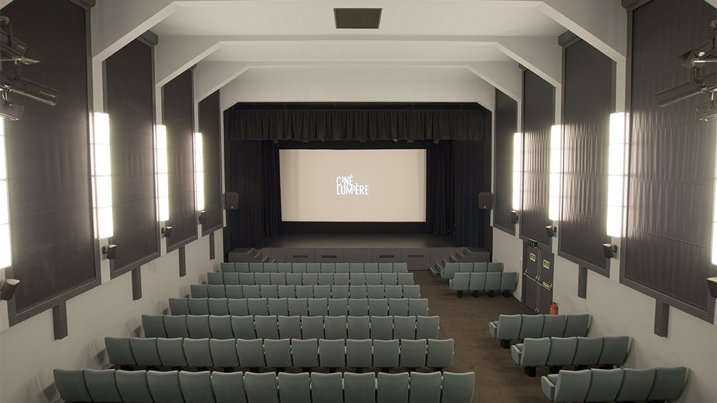 Ciné Lumière auditorium with tiered seating for presentations and screenings.