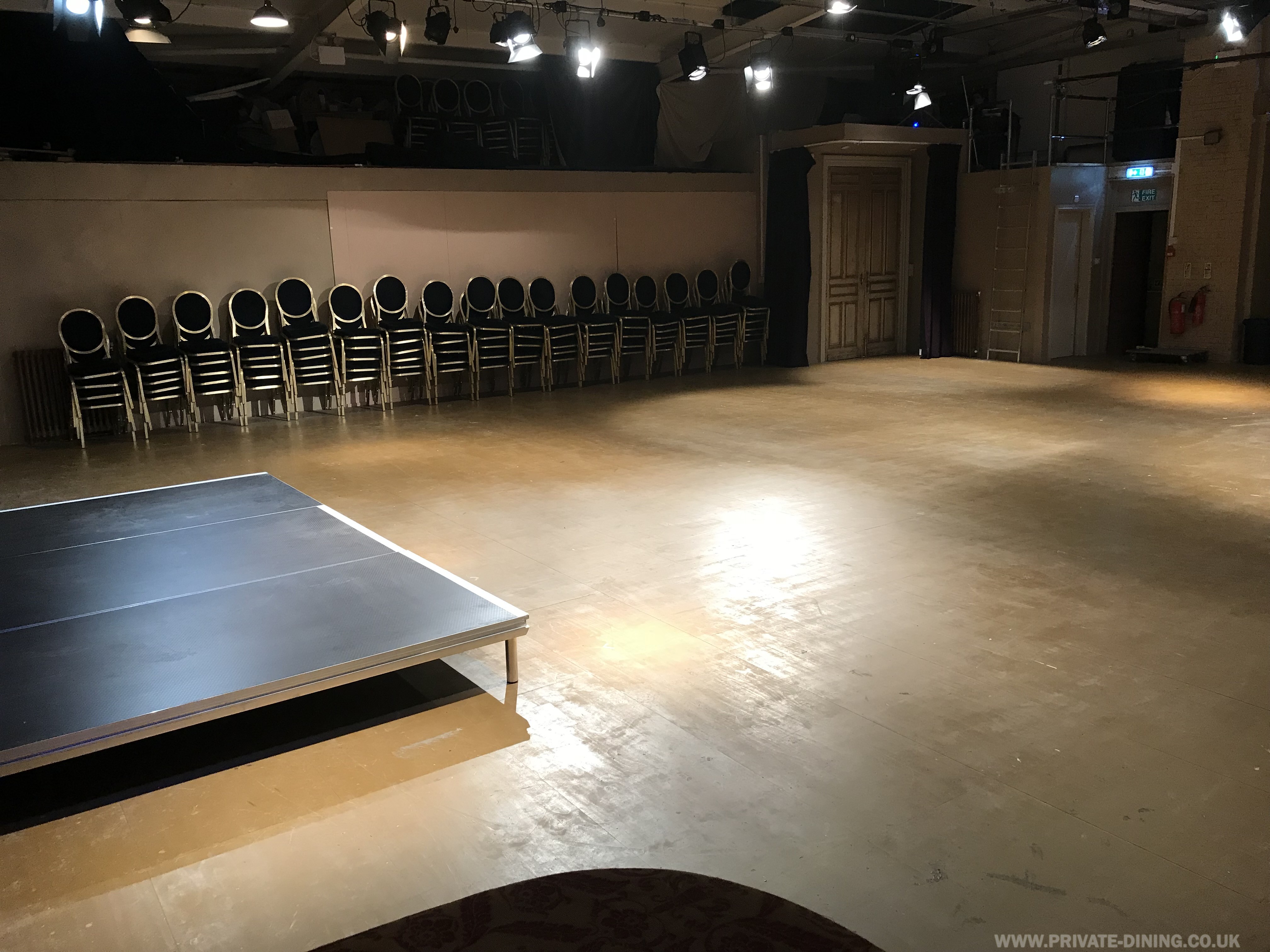 Versatile event space at The Playground Theatre with polished floor, ideal for conferences and workshops.