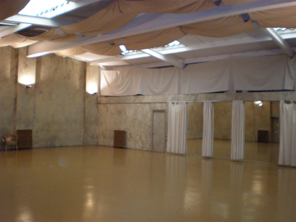 Spacious minimalist event space at The Playground Theatre for workshops and gatherings.
